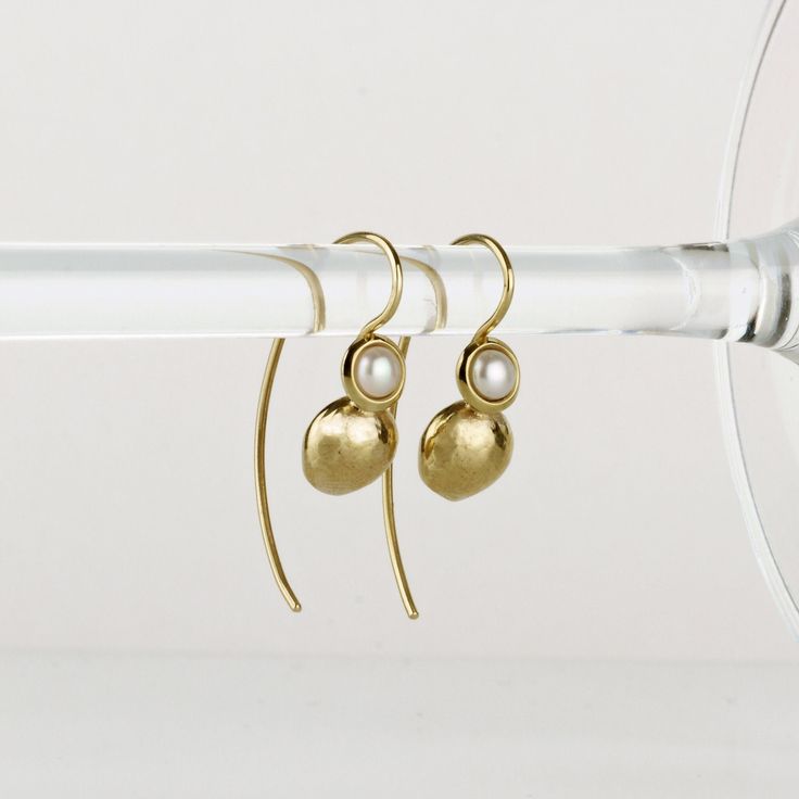 Delicate gold pearl earrings, handmade of yellow 14k solid gold and small round white freshwater pearls. The earrings have an organic feel, they are shiny and comfortable to wear. Classy and timeless, these gold earrings will add a fine soft touch to any outfit. They can be a perfect match for a pearl necklace, or a gold necklace. A wonderful gift for yourself or for someone you love. Total length of these earrings is approx. 2.9 cm = 1.14 inch (including ear wire) Length of the earring without the ear wire is 1.33 cm = 0.5 inch Pearl is about 3 mm in diameter = about 0.11 inch Silicone ear backs are included for safety. * The earrings will be packed in a gift box ready to give as a gift, and shipped via Express mail service which usually takes 4-6 business days to arrive. * For more gold Delicate Gold Earrings, Handmade Fine Jewelry, Solid Gold Earrings, Gold Pearl Earrings, Earrings Pearl, White Freshwater Pearl, Fine Jewelry Gift, Gold Drop Earrings, Gold Pearl