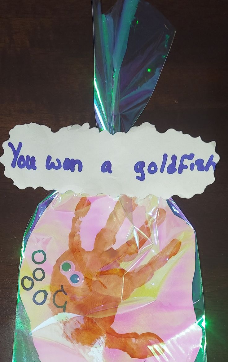 a plastic bag filled with handprints on top of a wooden table next to a sign that says, you can be a golffat