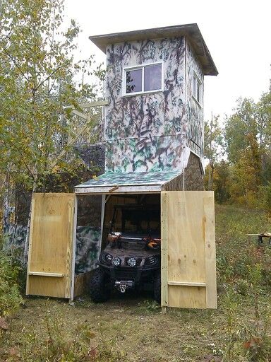 a truck is parked in front of a shed with its doors open and graffiti painted on it