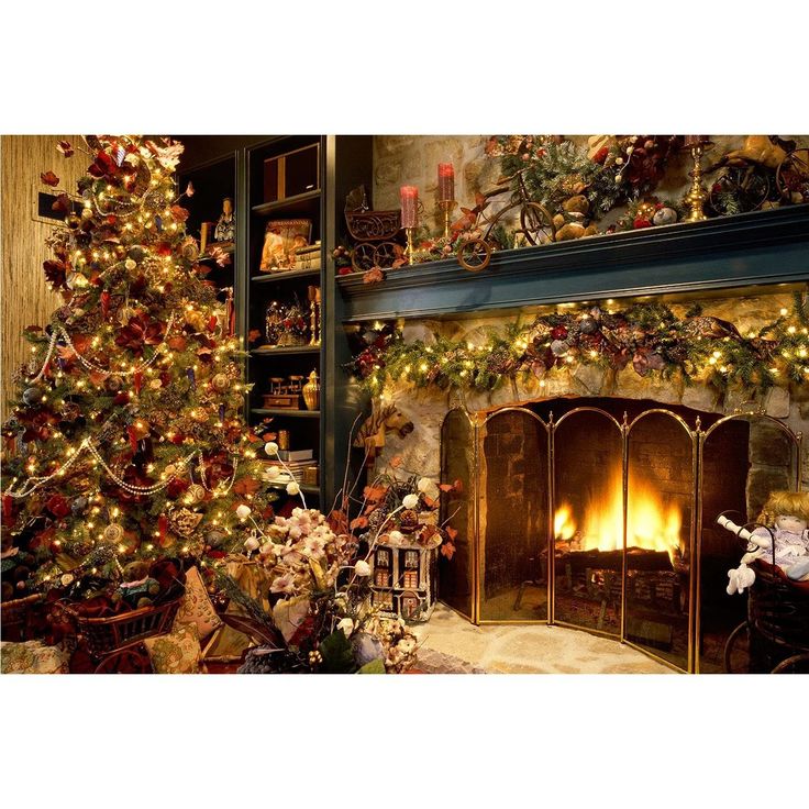 a christmas tree is lit in front of a fireplace