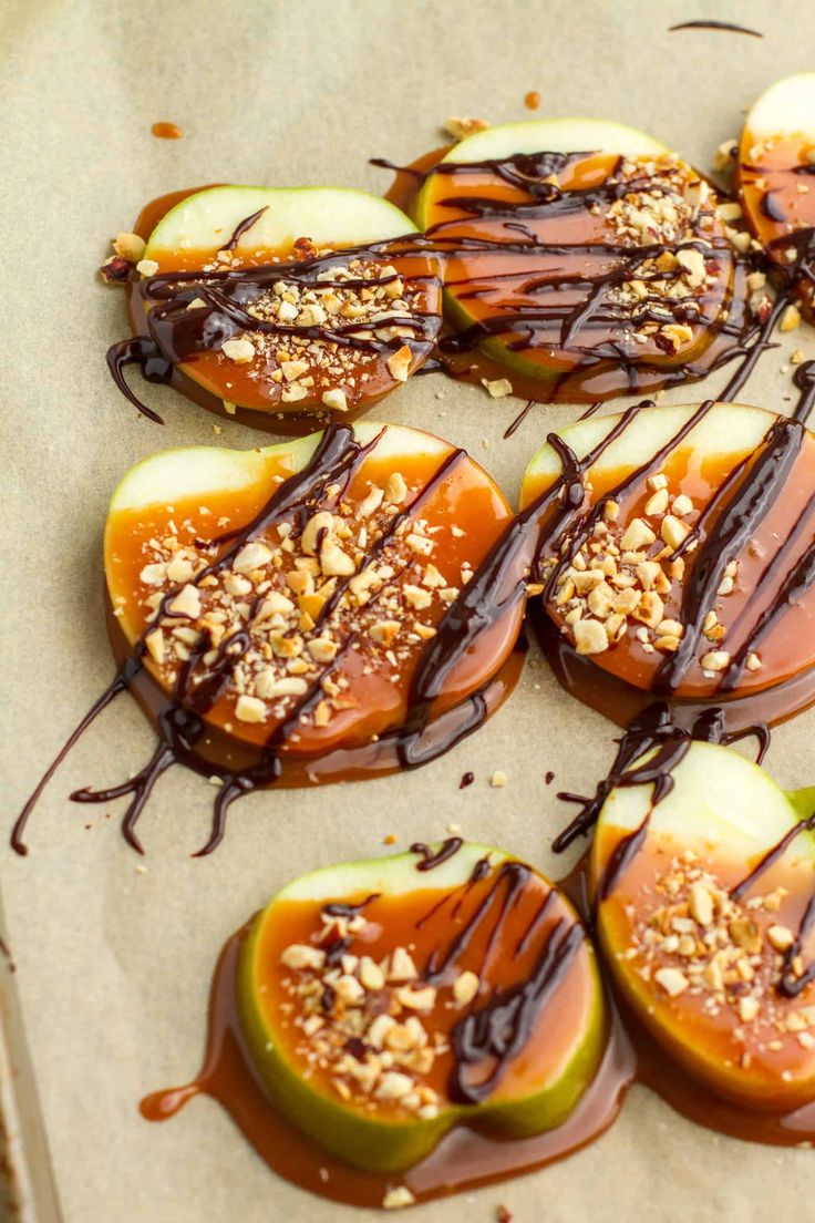 chocolate drizzled on apples with nuts and caramel