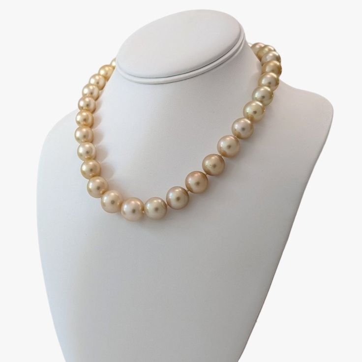 Indulge in the elegance and natural beauty of this stunning South Sea pearls necklace, featuring Golden South Sea pearls sourced from Indonesia. Crafted with meticulous attention to detail, this necklace is a testament to exceptional craftsmanship and exquisite materials.Secured with a 14K yellow gold 'twist and lock' clasp, the necklace measures 17.25 inches (43.5cm) in length, draping gracefully around the neckline. The weight of 95.7g adds a substantial feel and underscores the luxurious qual Luxury Pearl Necklaces With Round Beads, Luxury High Luster Necklaces For Formal Occasions, Luxury High Luster Pearl White Pearl Necklace, Luxury High Luster Pearl White Necklace, Formal Necklaces With Round High Luster Beads, Luxury High Luster Akoya Pearl Necklace, Formal High Luster Round Bead Necklaces, Formal High Luster Round Beaded Necklaces, Luxury Pearl White Round Beads Necklace