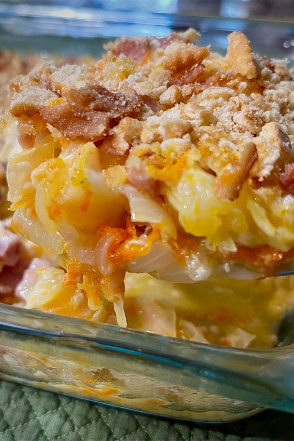 a casserole dish with ham, cheese and bread toppings in a glass baking dish