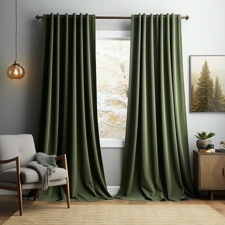 a living room with green curtains and a chair