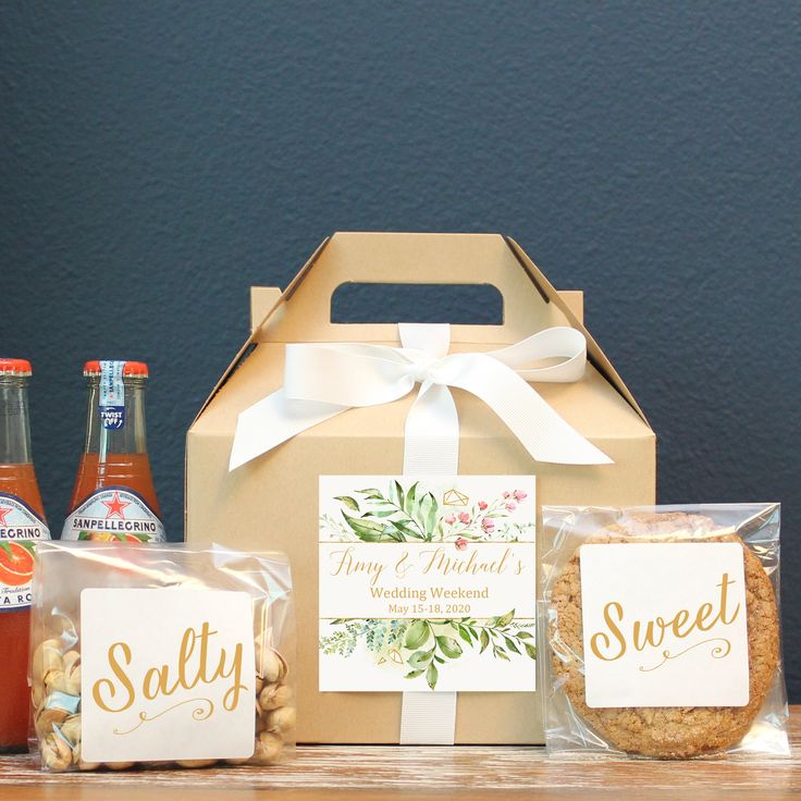 some food and drinks are sitting on a table with a gift box in the middle