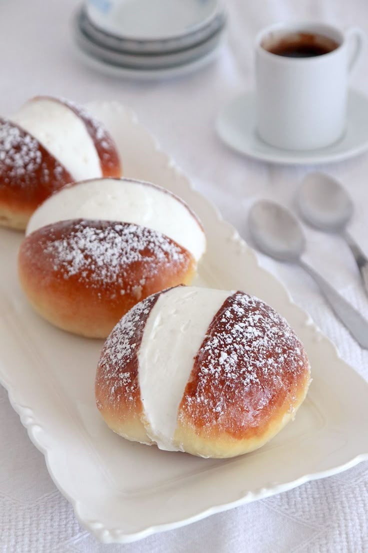 three powdered sugar covered pastries on a white plate