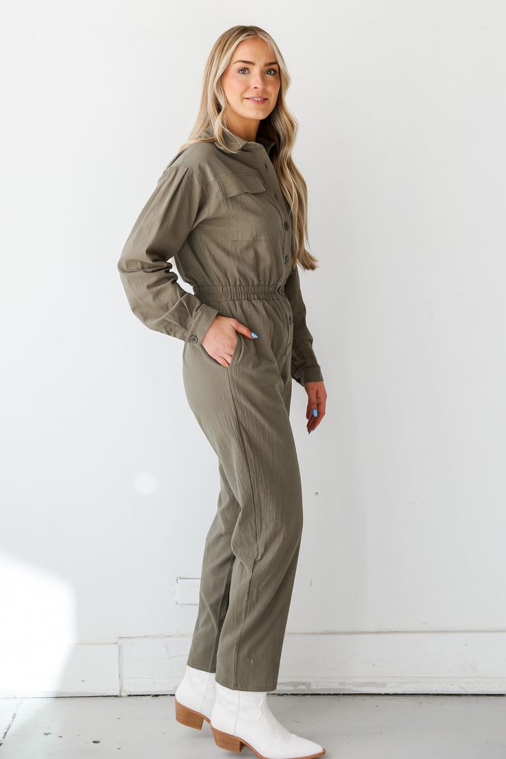 Prepare to leave everyone stunned by the way you strut in the Striking Attitude Olive Jumpsuit! This jumpsuit is designed to make a statement with its earthy olive hue, creating a look that is both effortlessly elegant and on-trend. Crafted from high-quality fabric, the olive jumpsuit offers a relaxed and comfortable fit, making it an ideal choice for various occasions. The rich olive color adds a touch of sophistication, allowing you to transition seamlessly from casual outings to more polished Khaki Utility Jumpsuits And Rompers, Utility Style Khaki Jumpsuits And Rompers For Fall, Utility Style Solid Color Jumpsuits And Rompers For Fall, Khaki Utility Overall Jumpsuits And Rompers, Khaki Utility Jumpsuit For Work, Khaki Utility Jumpsuits And Rompers For Workwear, Utility Style Khaki Jumpsuit For Work, Khaki Overalls For Fall, Khaki Fall Overalls