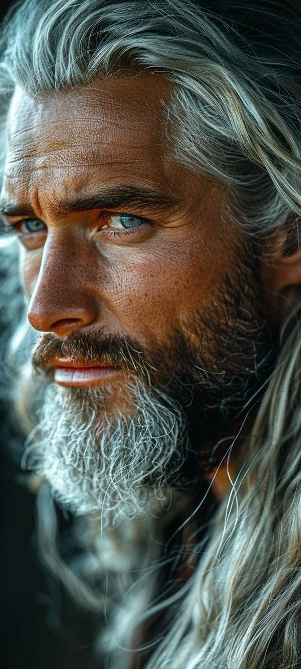 a man with long grey hair and blue eyes