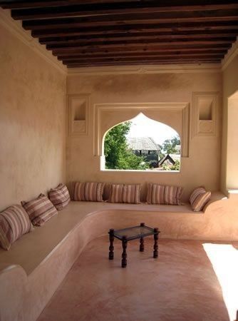 a couch sitting under a window in a living room