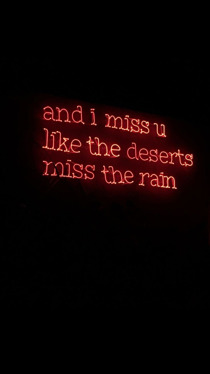 a red neon sign that says and i miss u like the deserts miss the rain