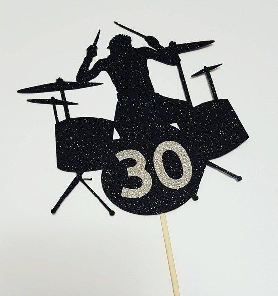 a cake topper with the number 30 on it, and a drummer playing drums