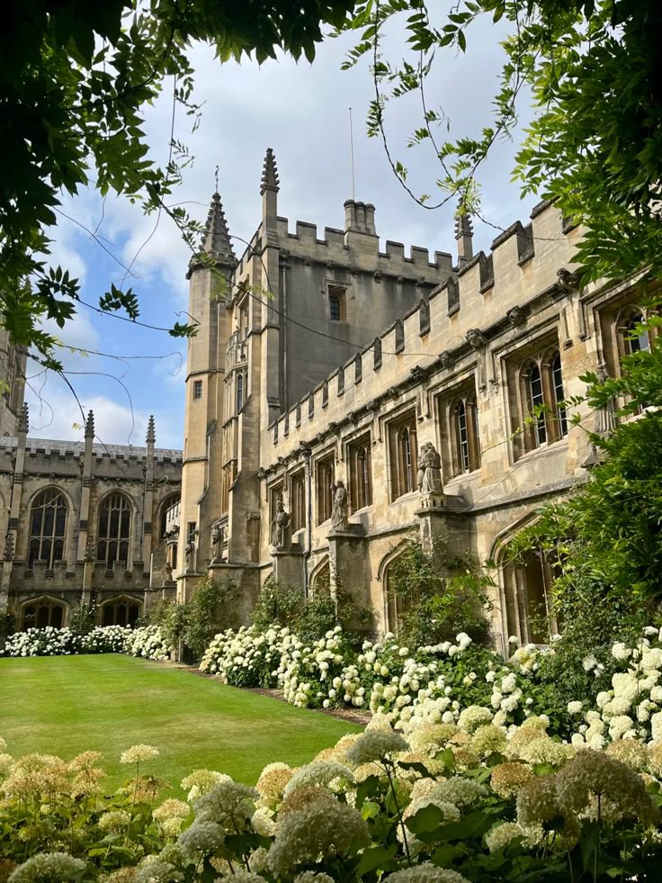 an old building with flowers in front of it