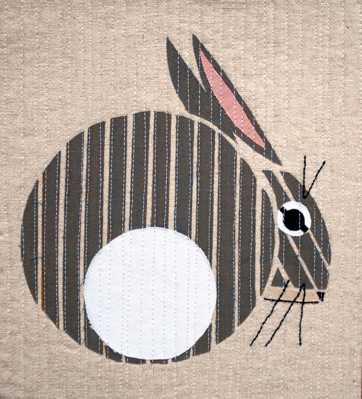 a close up of a piece of fabric with a rabbit on it's face