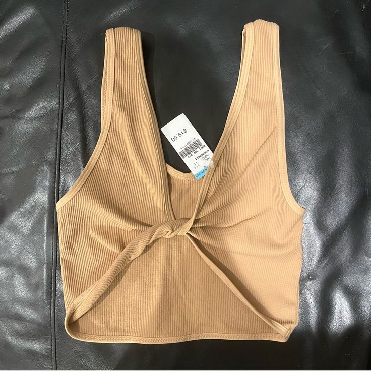 Seamless Tank Crop Top One Size Never Worn / New With Tags Beige Seamless V-neck Crop Top, Beige Seamless Crop Top For Spring, Spring Beige Seamless Crop Top, Chic Seamless Brown Crop Top, Chic Brown Seamless Crop Top, Trendy Brown Tank Top For Beach, Trendy Brown Tank Top For The Beach, Beige Seamless Crop Top For Summer, Trendy Brown Beach Tank Top