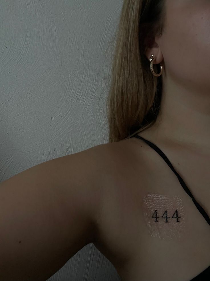 a woman with a small tattoo on her chest