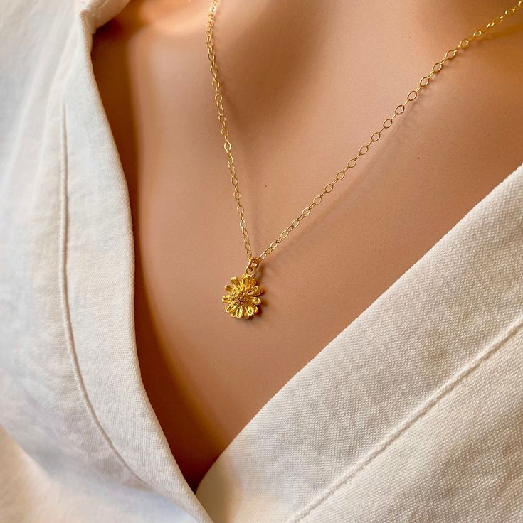 A beautiful small, shiny gold flower with lots of detail is hung on a delicate yet sturdy 14K Gold-Filled Chain. Sweet and simple. Feminine and charming. - Pendant - 14k Gold plated Brass - 9mm in diameter - Chain + components - 14K Gold-Filled - Clasp - 14K Gold-Filled lobster clasp . . . . . . . . . . . . . . . . . . . . . . . . . . . . . . . .  Want more for bridesmaids, sisters or friends? I am happy to put custom orders together! . . . . . . . . . . . . . . . . . . . . . . . . . . . . . . . .  Necklace arrives packaged for giving. Dainty Flower Charm Necklace For Wedding, Yellow Gold Charm Necklace With Flower For Wedding, Gold Flower Charm Necklace For Anniversary, Gold Charm Necklace With Flower For Anniversary, Yellow Gold Flower Charm Necklace, Dainty 14k Gold Charm Necklace With Flower Charm, Delicate Yellow Gold Jewelry With Flower Charm, 14k Gold Flower Charm Necklace With Pendant, 14k Gold Flower Pendant Charm Necklace