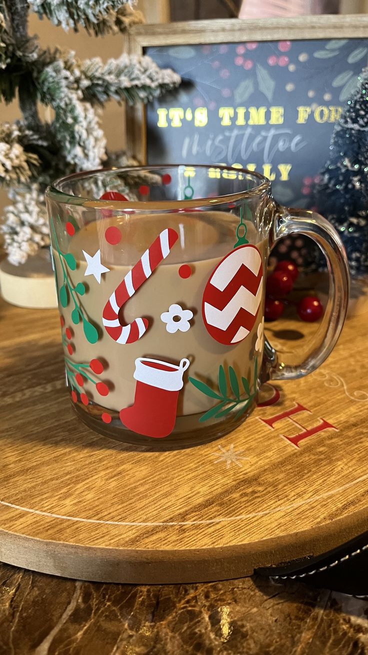 a coffee mug with candy canes and christmas decorations on the inside is sitting on a table