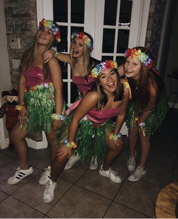 the girls are all dressed up in hula skirts