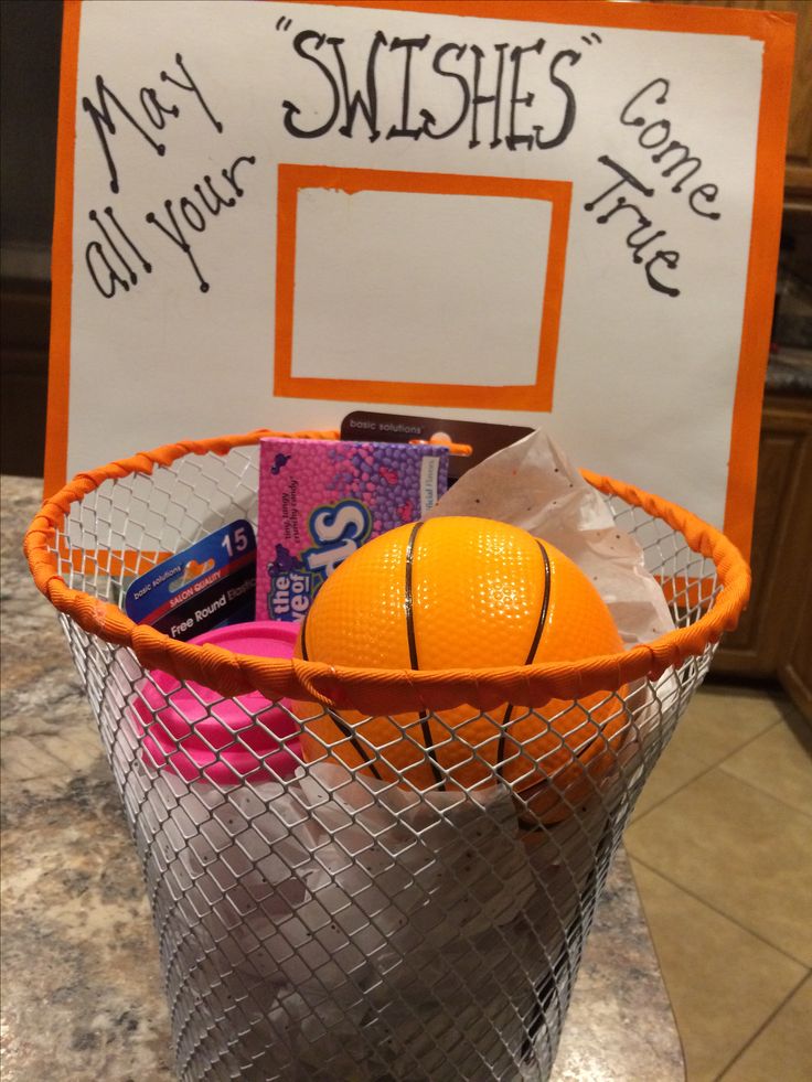 a basket filled with candy and an orange basketball sitting on top of a counter next to a sign that says, not all your wishes come true