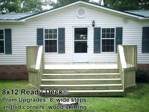 a deck with steps leading up to the front door and two windows on each side