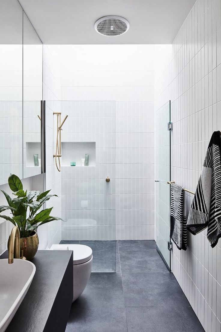 a modern bathroom with black and white tiles on the walls, flooring and accessories