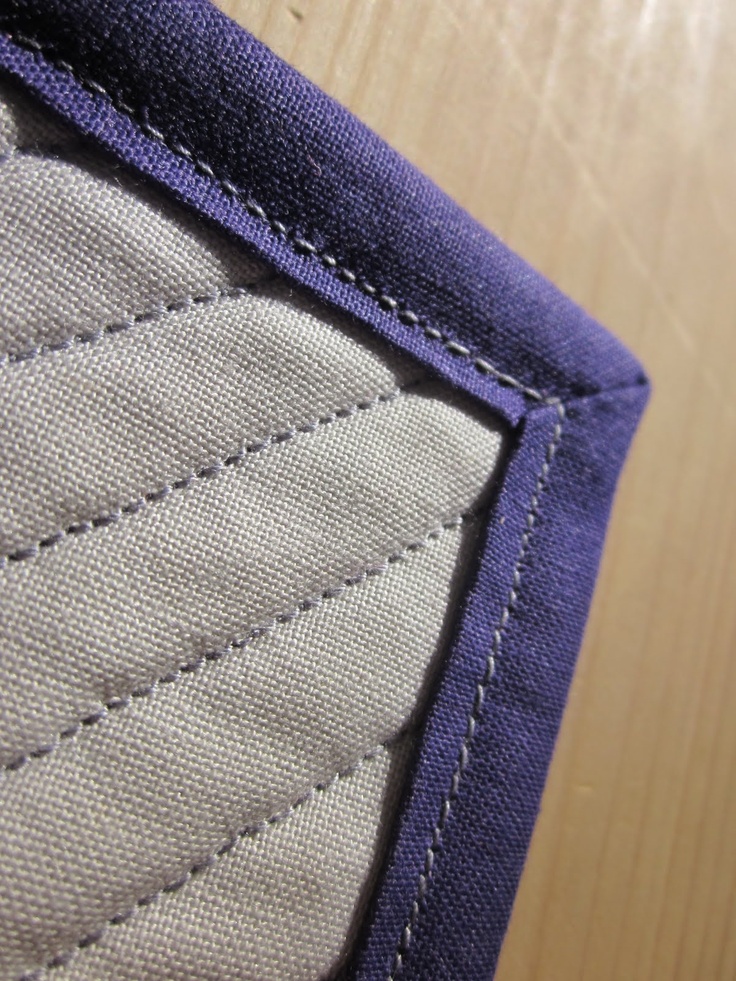 a close up view of the inside of a blue and white piece of cloth on a wooden surface