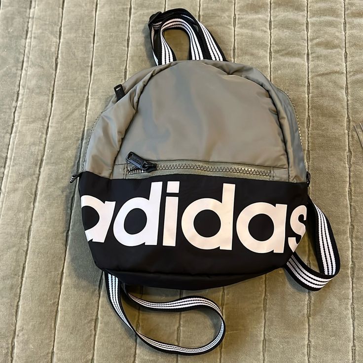 Olive Green Color Adidas Back Pack Nwot, Never Used, Great Condition. Smoke Free Home. 100% Polyester. Measures 10 1/2 Inches Tall By 9 Inches Wide. Straps Are Black And White Stripe. Adidas Everyday Bags For Back To School, Casual Adidas Backpack For Everyday Use, Adidas Casual Everyday Backpack, Trendy Adidas Backpack For Back To School, Trendy Adidas Backpack For Everyday Use, Adidas Nylon Backpack For Everyday Use, Casual Adidas Shoulder Bag For School, Trendy Adidas Shoulder Bag For Everyday Use, Casual Adidas Bags With Zipper Closure