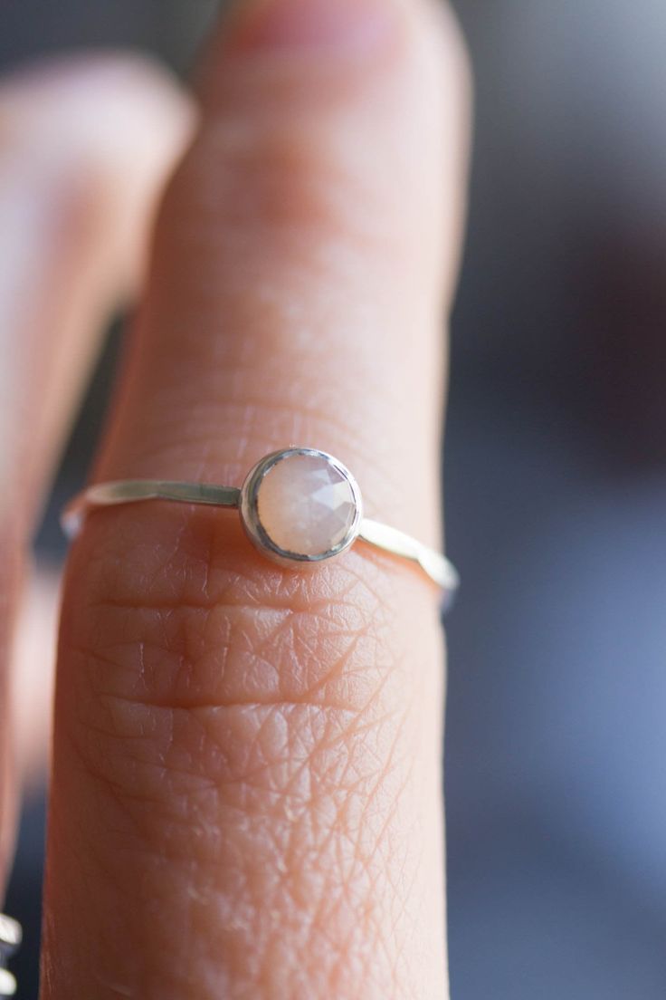 Tiny skinny stackable ring with beautiful Peach Moonstone. It is made with a skinny but sturdy band, perfect for everyday wear. It is a gentle and delicate piece, which you may wear alone or stacked. It is a great every-day jewel which will perfectly suit any occasion and any outfit. The ring is 0,8-0,9 mm thick and looks very dainty on the finger. Choose the size of the stone (3 or 5 mm) and material for the ring (sterling silver or 9k gold). If you want to change the ring band design or get a Adjustable Minimalist Moonstone Ring In Sterling Silver, Minimalist Adjustable Sterling Silver Moonstone Ring, Dainty Adjustable Moonstone Ring For Everyday, Delicate Sterling Silver Moonstone Ring, Adjustable Stackable Moonstone Promise Ring, Adjustable Stackable Moonstone Ring For Everyday, Delicate Moonstone Promise Ring, Delicate Moonstone Ring, Delicate Tiny Sterling Silver Stackable Rings