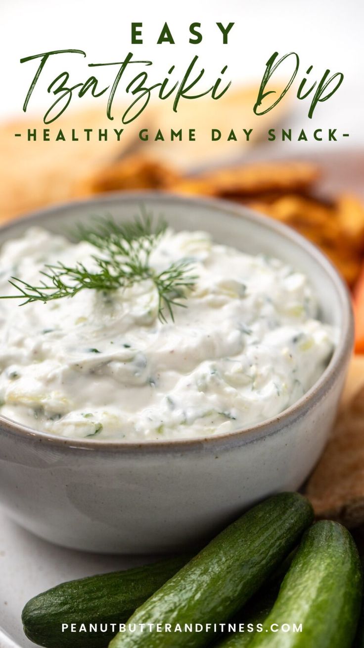 a white plate topped with cucumbers and dip