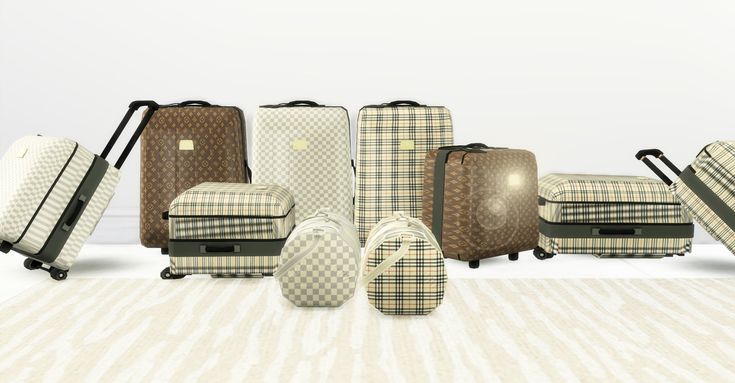 several pieces of luggage sitting on top of a white rug in front of a wall