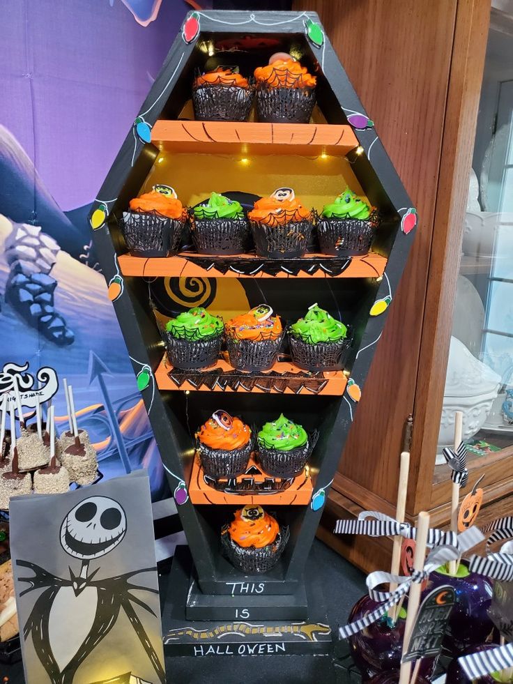 cupcakes are arranged in the shape of a hexagonal tower with halloween decorations