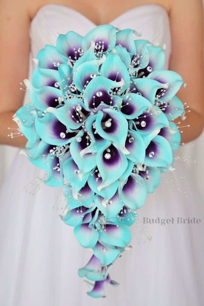 a bride holding a bouquet of blue flowers