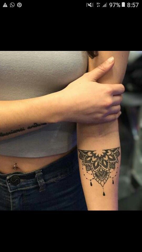 two women with tattoos on their arms and one is showing off her arm tattoo design