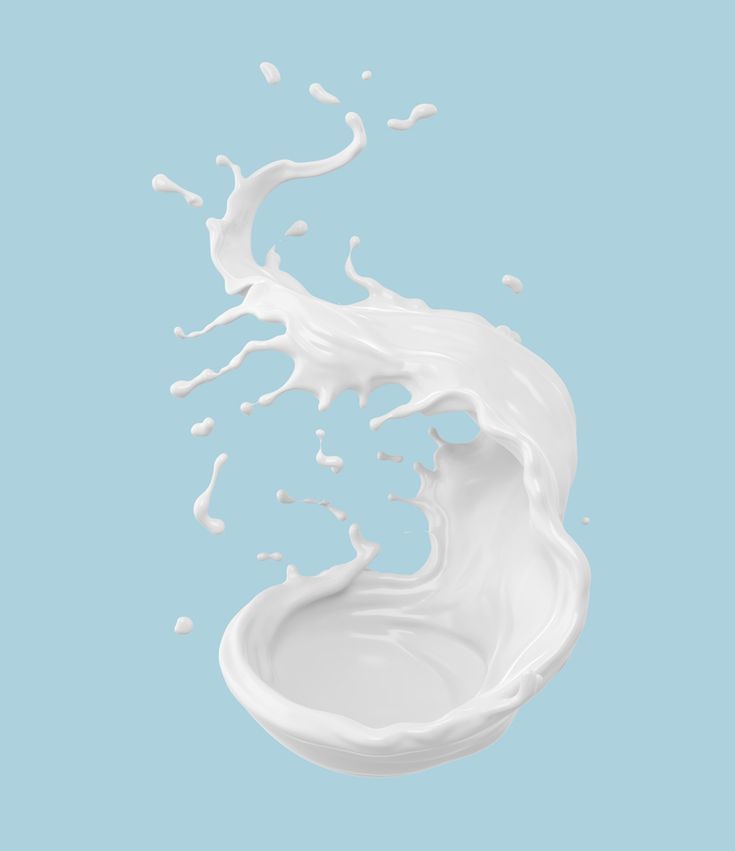 milk splashing into the air on a blue background