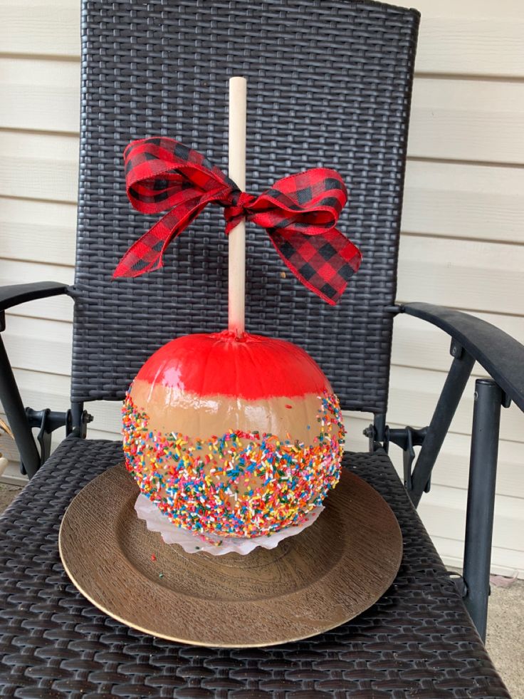 a decorated pumpkin sitting on top of a chair