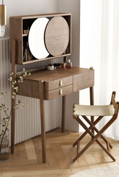 a dressing table with mirror and stool in a room