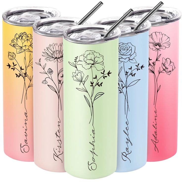 four different colored cans with straws and flowers on the lids, one is empty