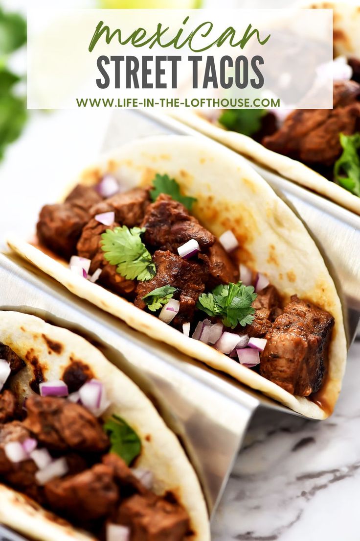 three tacos with meat, onions and cilantro