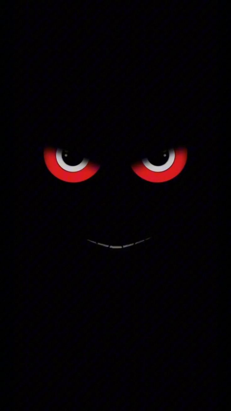 an evil looking face with red eyes in the dark