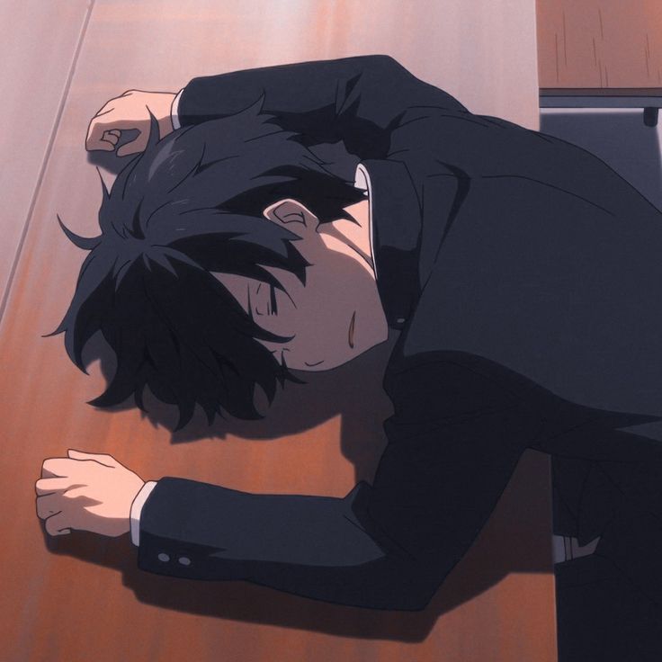 an anime character laying on the floor with his head down