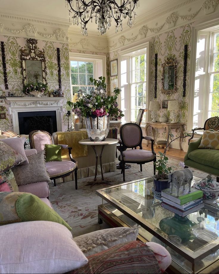 a living room filled with lots of furniture and a chandelier above a fire place