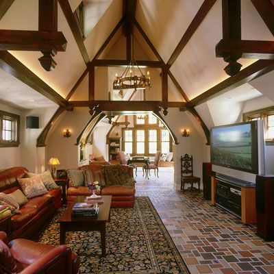 a living room filled with lots of furniture and a flat screen tv mounted to the wall