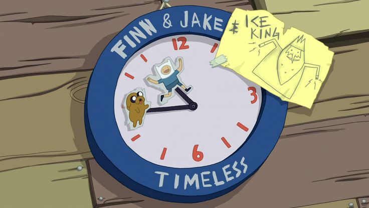 a cartoon clock that is on the side of a wooden wall with a piece of paper next to it