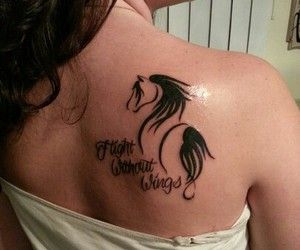 a woman with a horse tattoo on her shoulder