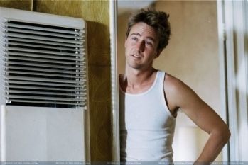 a man standing in front of an air conditioner