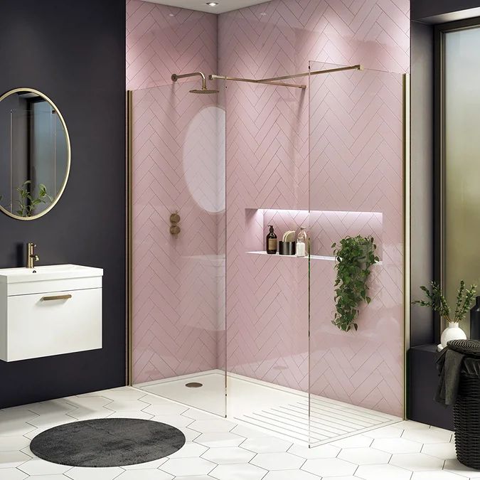 a bathroom with pink walls and tile flooring