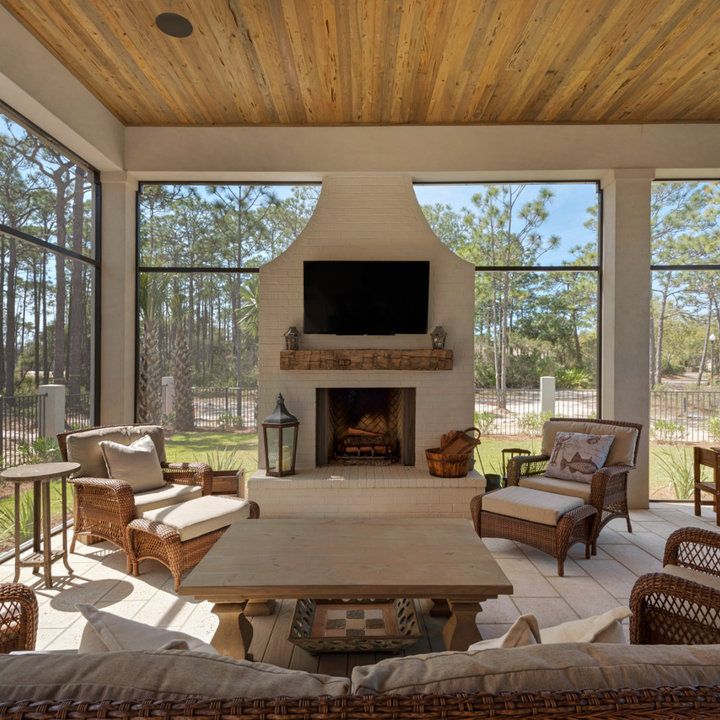 a living room filled with furniture and a flat screen tv mounted to the wall above a fireplace