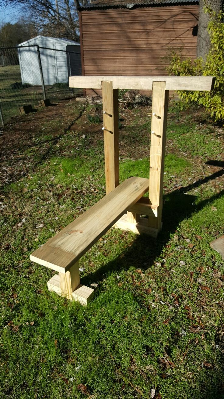 a wooden bench sitting on top of a lush green field