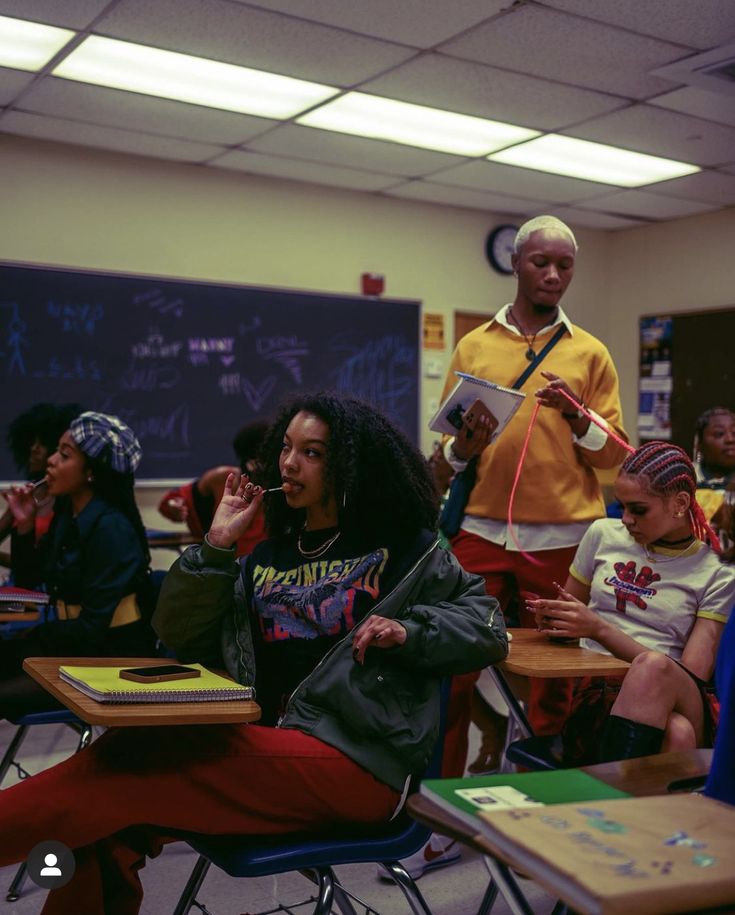 a group of young people sitting at desks in a classroom