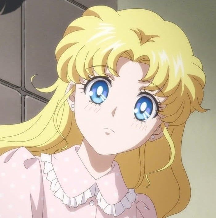 a blonde haired girl with blue eyes looking at the camera